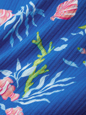Close-up of a blue fabric with tropical sea and shell patterns