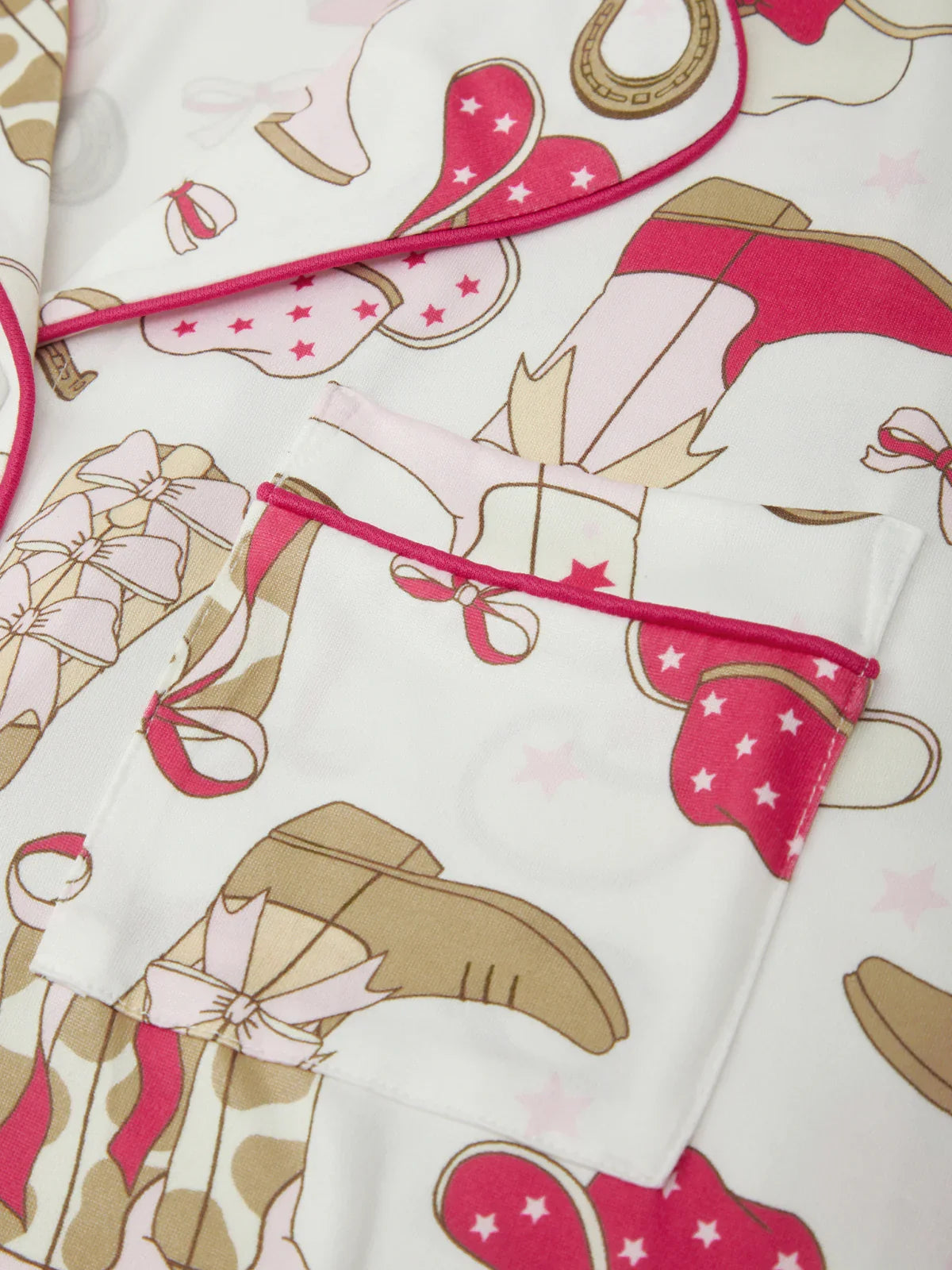 Close-up of a patterned fabric with pink and brown elements on a white background