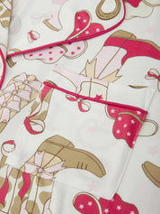 Close-up of a patterned fabric with pink and brown elements on a white background