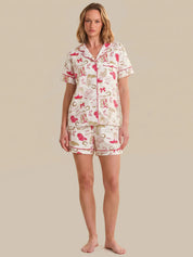 Woman wearing a patterned pajama set on a beige background
