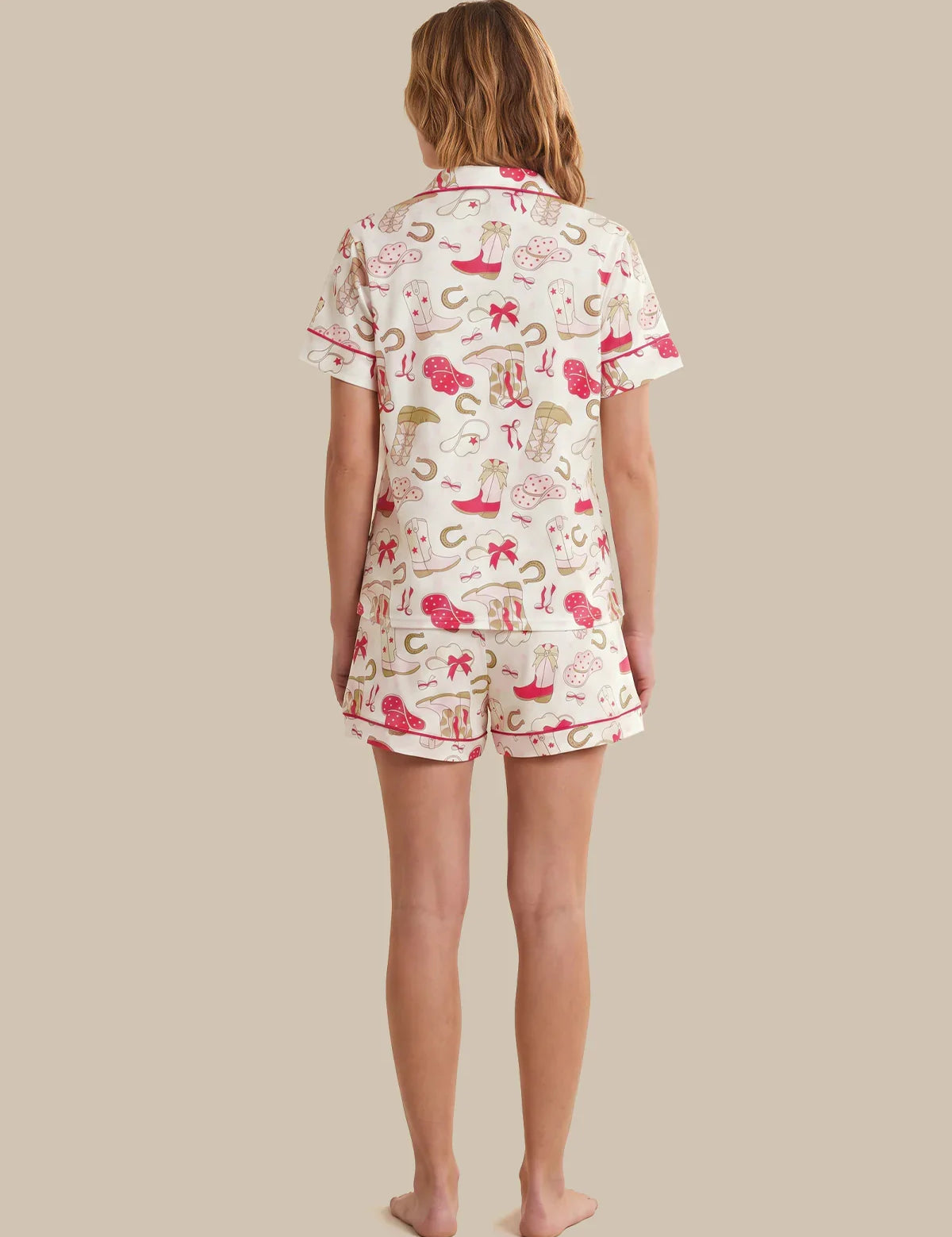 Person wearing a patterned pajama set on a beige background