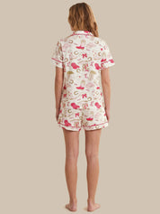 Person wearing a patterned pajama set on a beige background