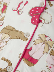Fabric with pink shoes, bows, and horseshoes on a white background