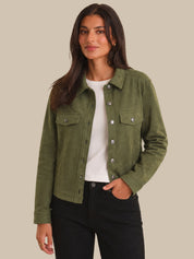 Woman wearing a green jacket with a plain background