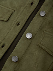 Close-up of a green coat with buttons on a dark background