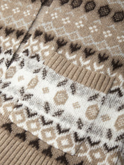 Close-up of a knitted cardigan featuring a Fair Isle pattern in beige, white, and dark brown, with ribbed knit trim.