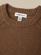 Close-up of a brown ribbed-knit sweater neck with a white interior label reading 89th Madison.