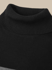 Close-up of a black ribbed knit turtleneck sweater against a solid beige background.