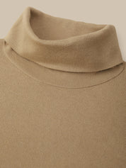 Close-up of a beige ribbed knit turtleneck sweater showing the collar and upper chest against a matching light beige background.