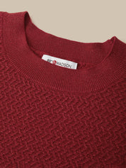 Close-up of a textured knit crewneck sweater in deep burgundy red, showing a white neck label with the brand name '88th & MADISON'.