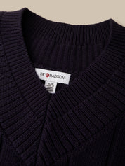 Close-up of a dark navy ribbed knit sweater with a white neck label reading 89 MADISON.