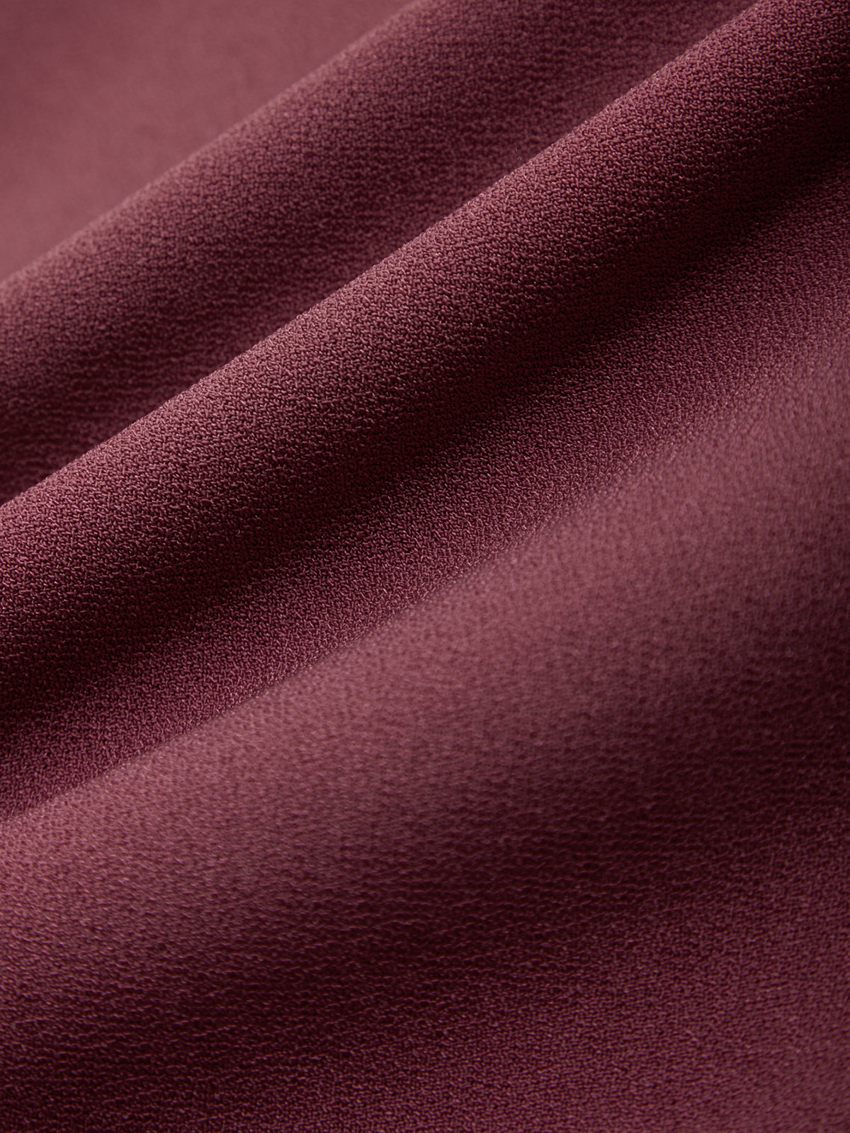 Close-up of a textured purple fabric surface