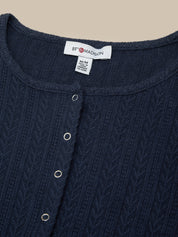 Navy blue garment with a brand label on a beige background