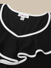Close-up of a black ruffled top with white trim, showing a white neck label that reads 8F MADSON.
