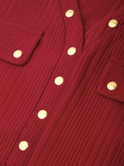 Close-up of a red ribbed corduroy garment with gold-tone snap buttons and flap pockets.