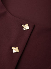 Close-up of a burgundy fabric with gold buttons