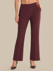 Maroon pants worn by a person on a beige background