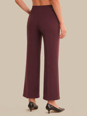 Maroon pants worn by a person on a beige background