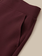 Close-up of a maroon fabric with a beige background