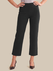 Black cropped wide-leg pants shown on a model from the waist down, paired with dark brown pointed-toe heels against a solid beige background.