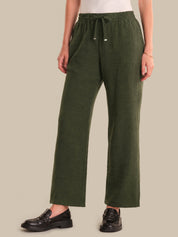 Person wearing green pants on a beige background