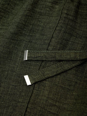 Close-up of a dark green fabric with a subtle pattern