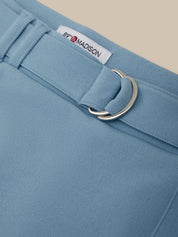 Close-up of a light blue garment with a belt and '89 Madison' label.