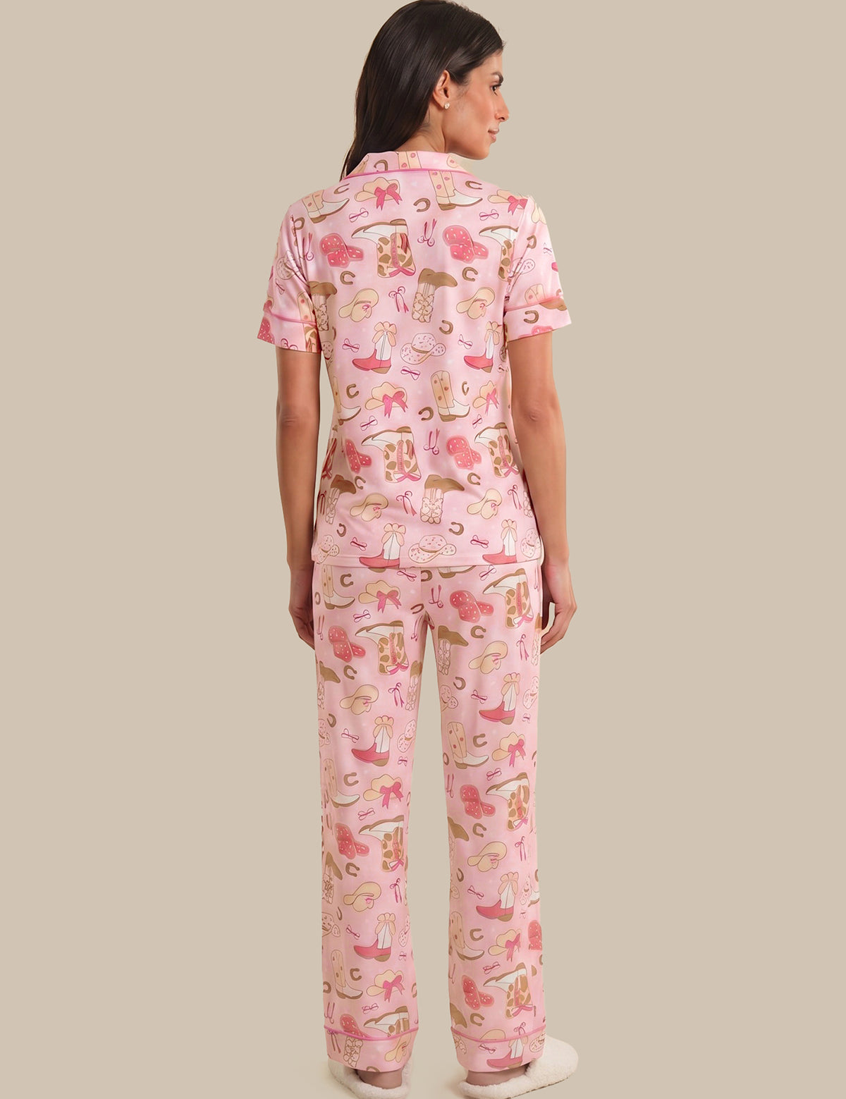 Woman wearing pink pajamas with animal print on a beige background