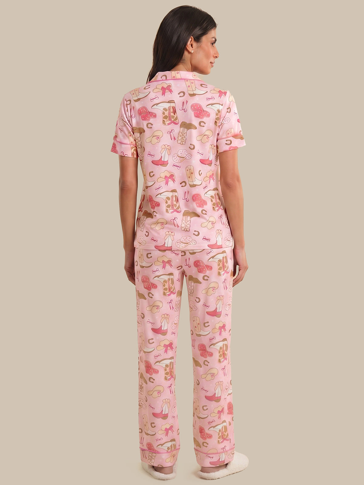 Woman wearing pink pajamas with animal print on a beige background