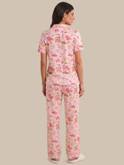 Woman wearing pink pajamas with animal print on a beige background