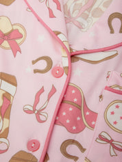 Pink fabric with horse-themed patterns including boots, horseshoes, and stars.