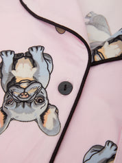 Pink fabric with cartoonish animal design and button