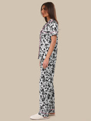 Woman wearing a floral dress on a beige background