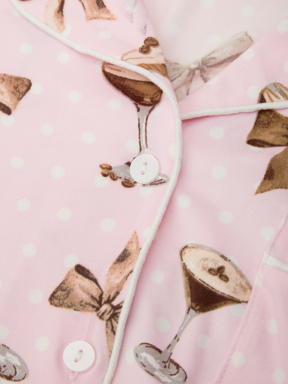 Close-up of a pink fabric with bow and cocktail pattern