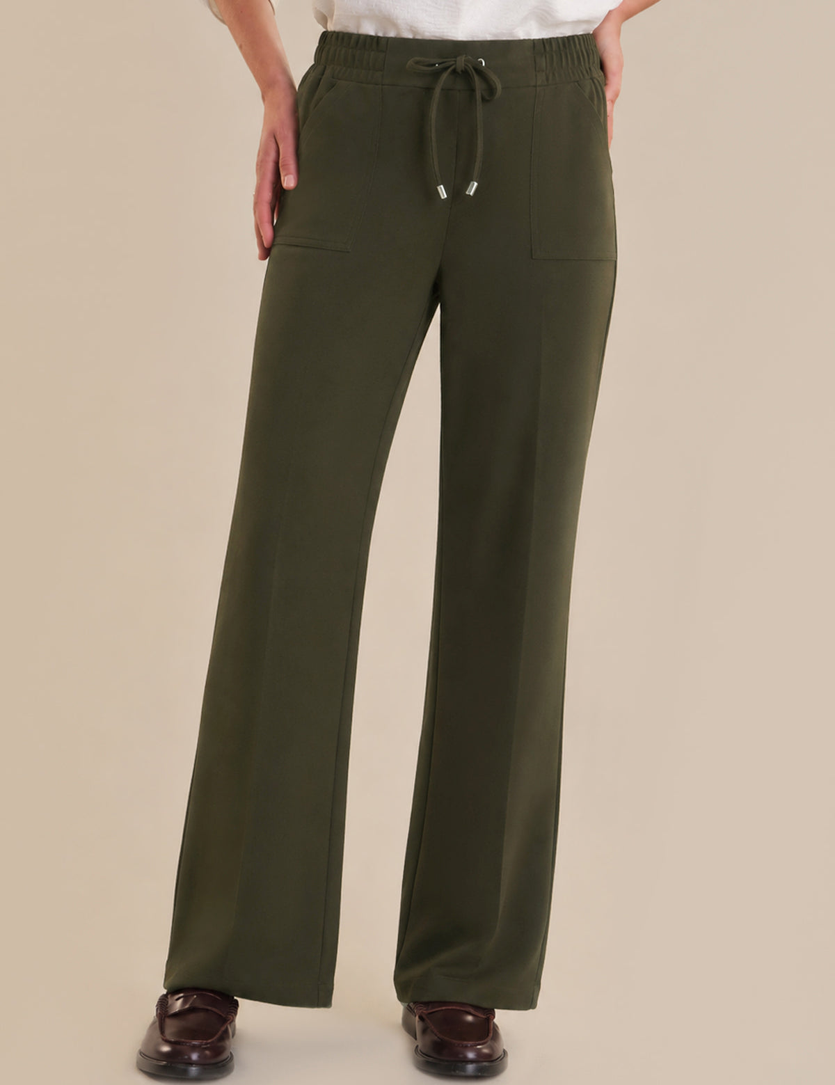 Green pants with a drawstring on a beige background