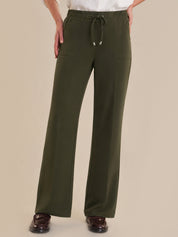 Green pants with a drawstring on a beige background