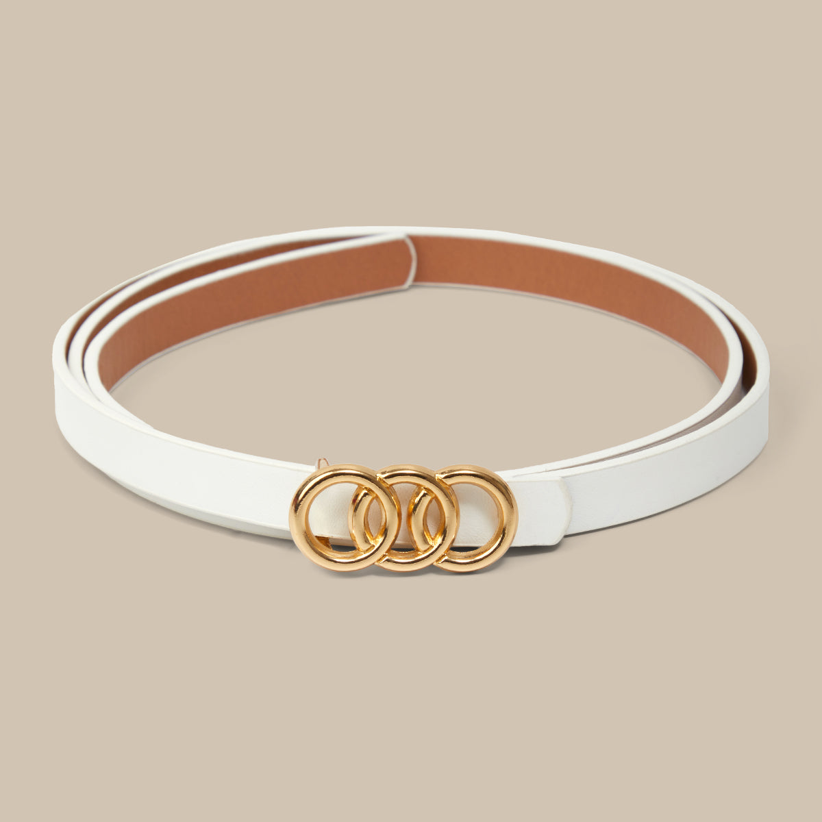 White belt with gold rings on a beige background