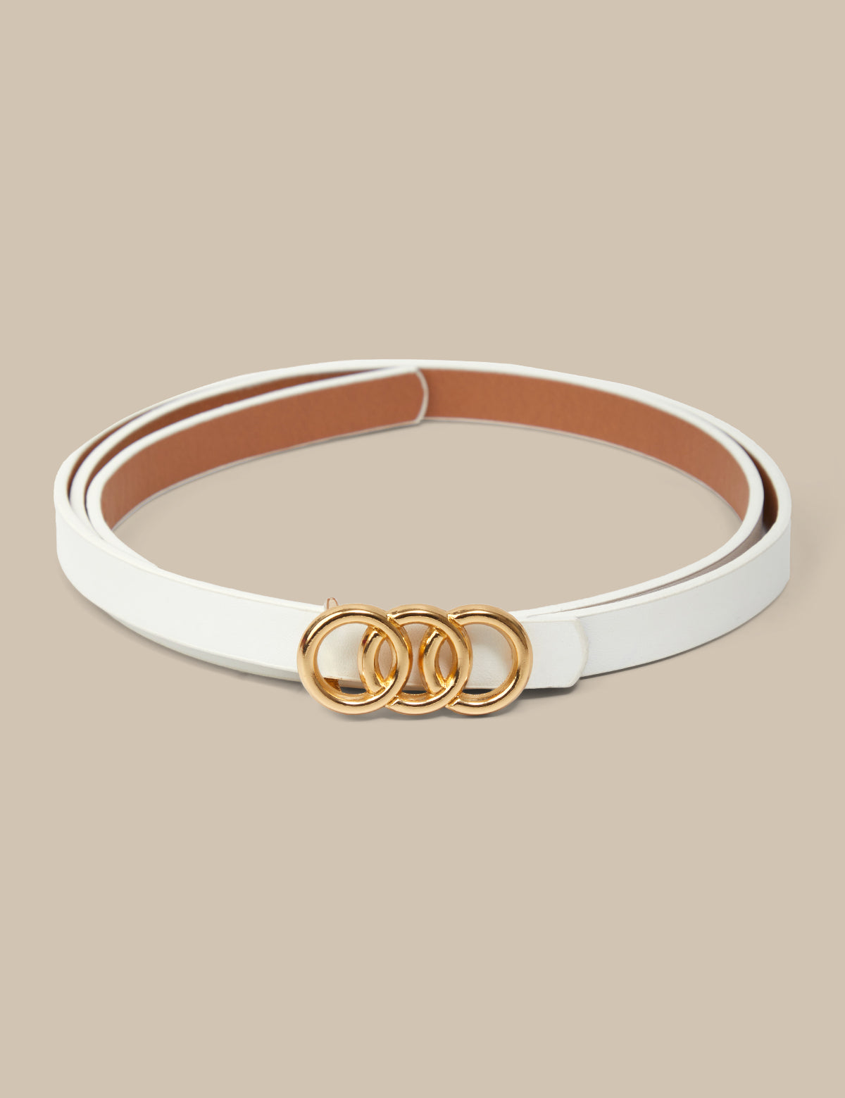 White belt with gold rings on a beige background