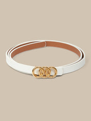 White belt with gold rings on a beige background