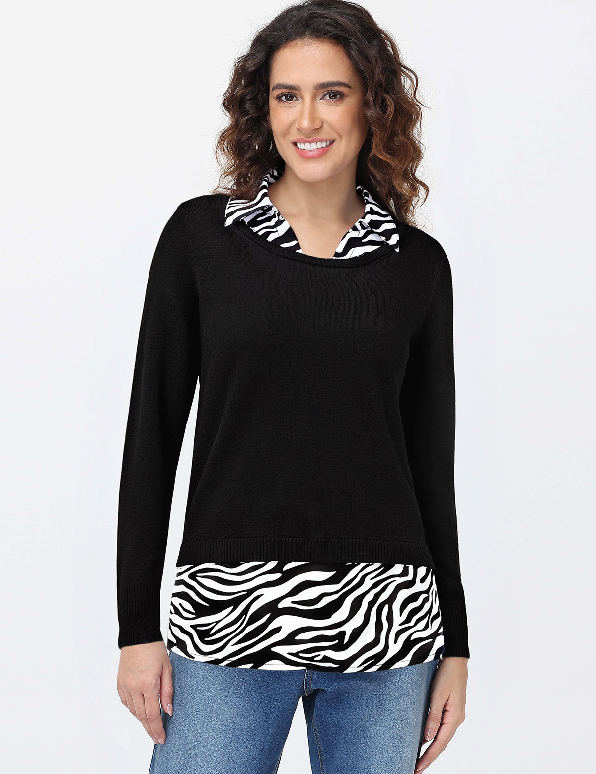 Woman wearing a black sweater with zebra print accents on a white background