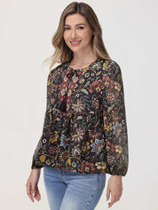 Woman wearing a floral blouse with long sleeves on a white background