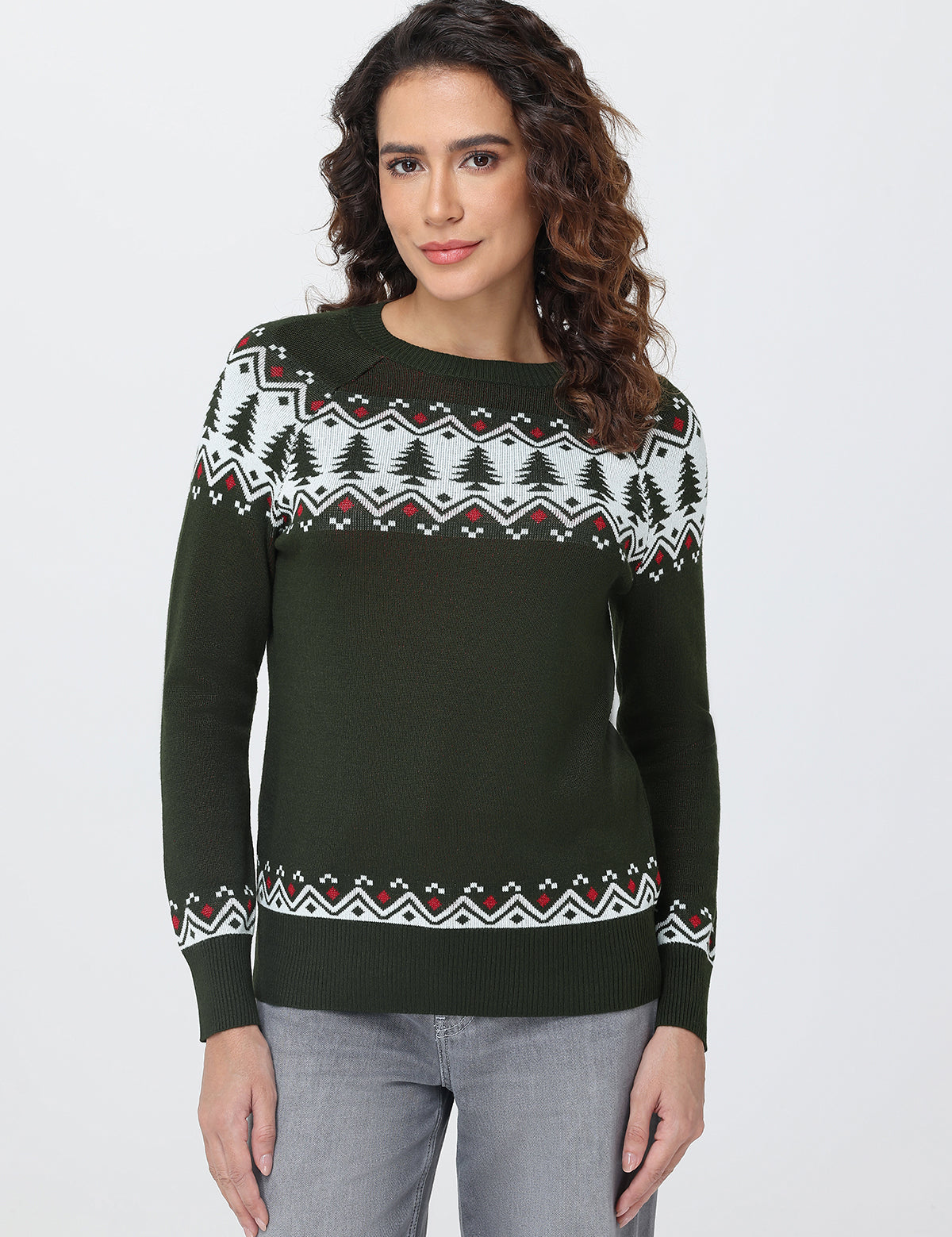 Woman wearing a green sweater with a patterned design on a white background