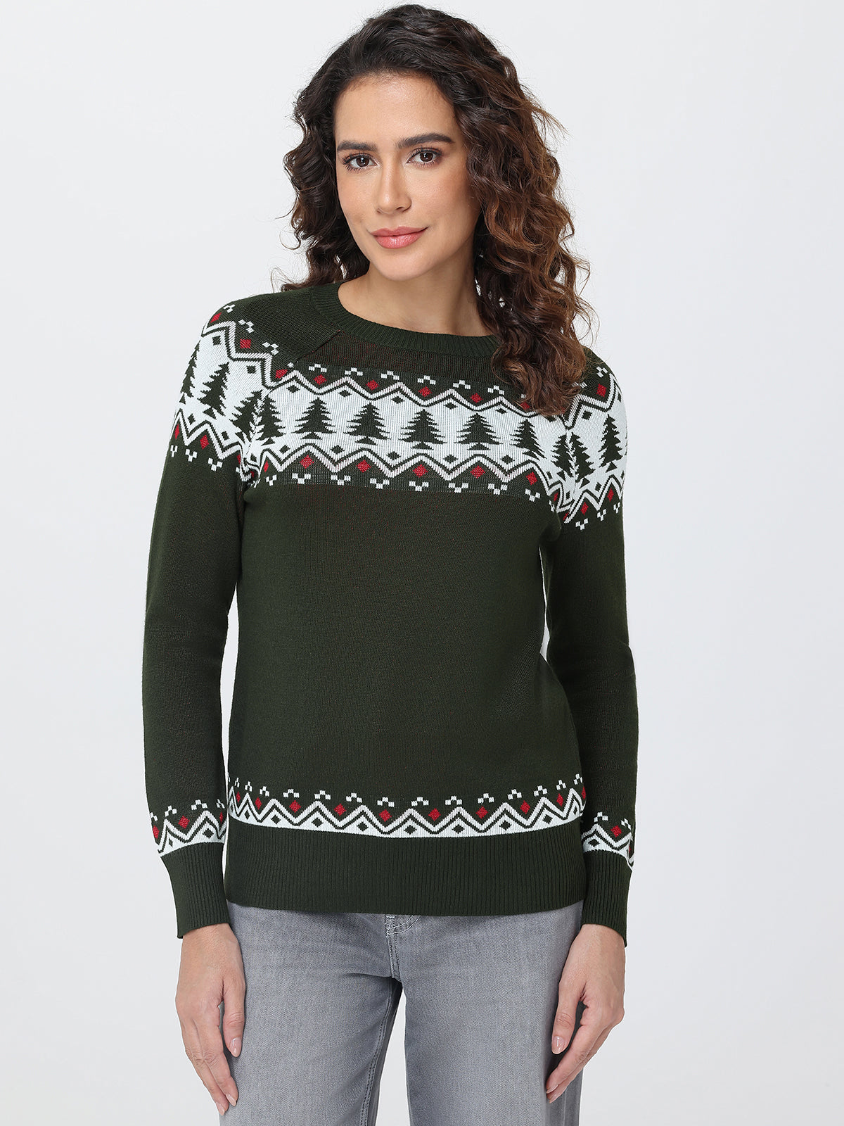 Woman wearing a green sweater with a patterned design on a white background