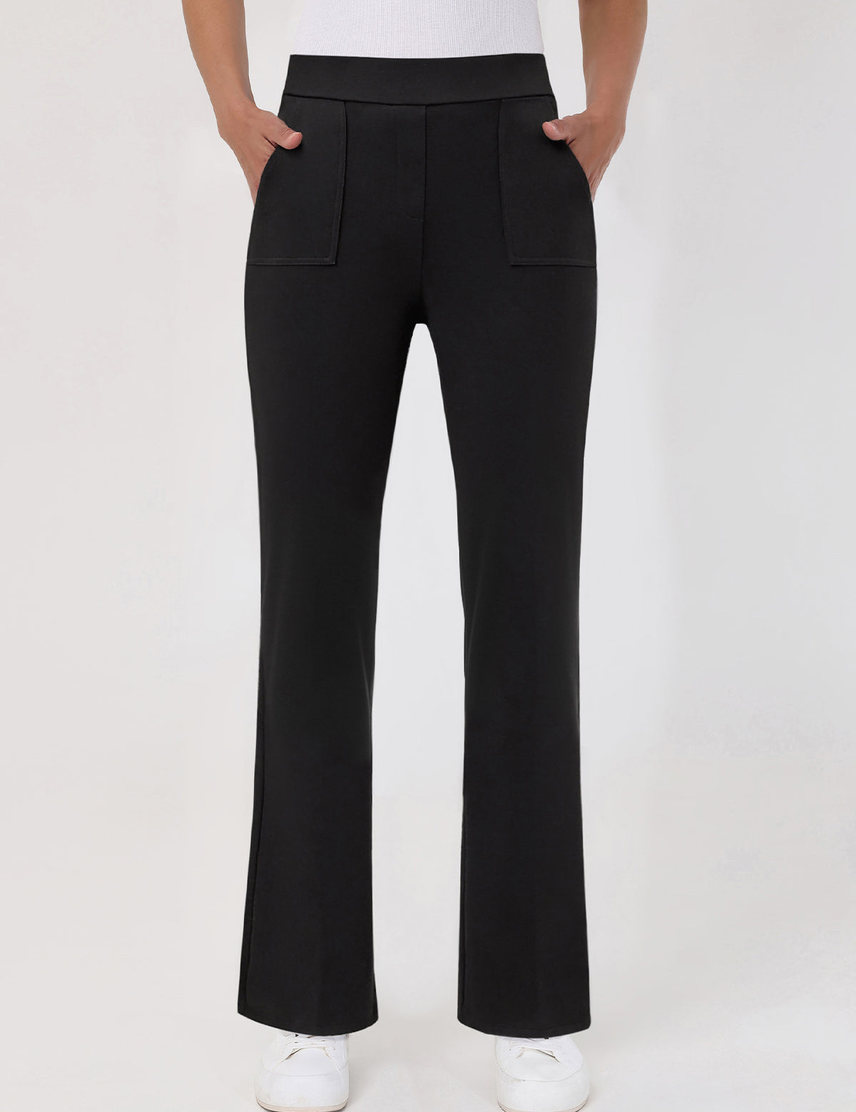 Black pants worn by a person on a white background